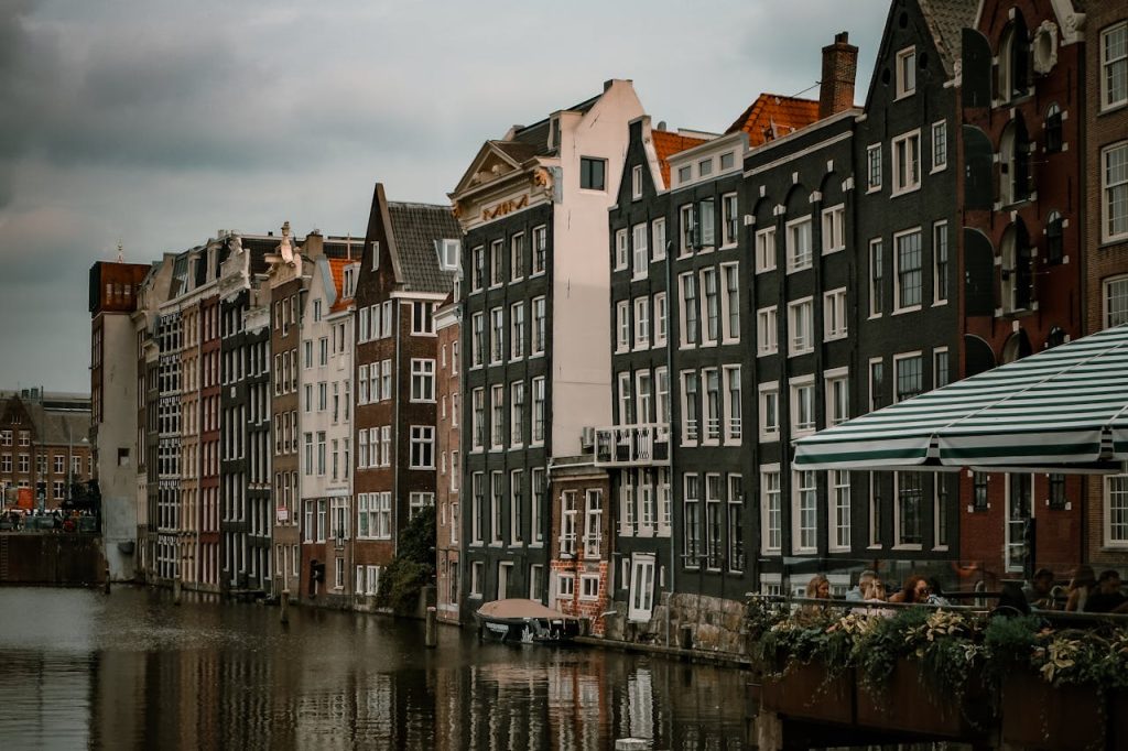 Picturesque view of historic Amsterdam canal houses with a warm vintage feel.